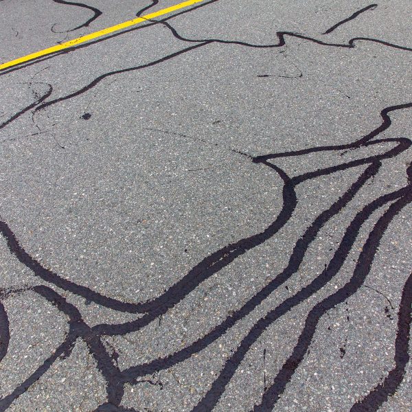Asphalt,Road,With,Filled,Cracks.,Background,Of,The,Fixed,Road